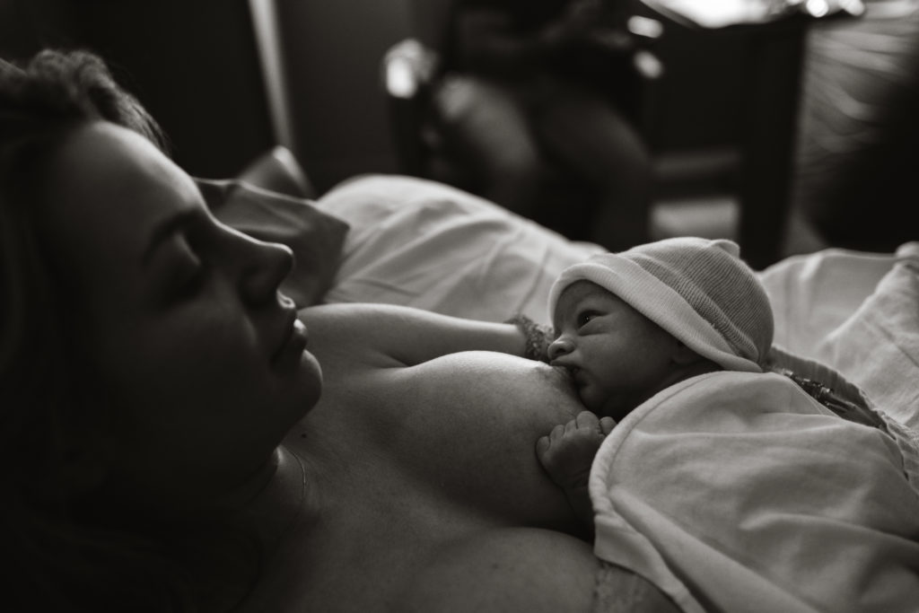 birth photographer, Newborn atlanta baby gazing at mother during breastfeeding 
