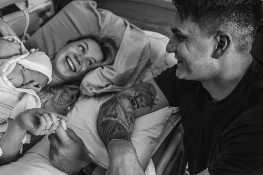 New father and mother joyous of newborn birth captured by birth photographer in Kansas City 