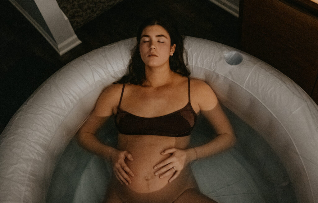 Mom resting in birth tub during early labor